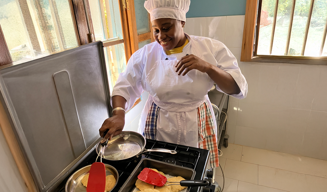 woman smiling and cooking