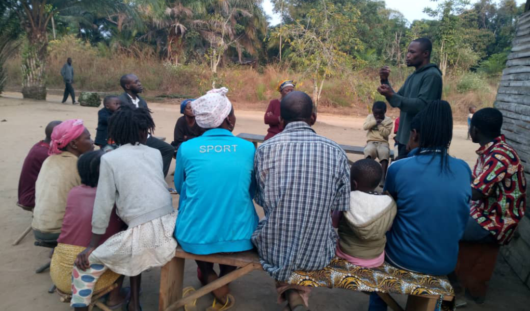 group sitting listening to a man speaking
