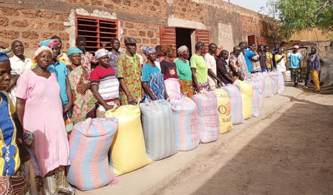 Line of people with colorful bags of supplies