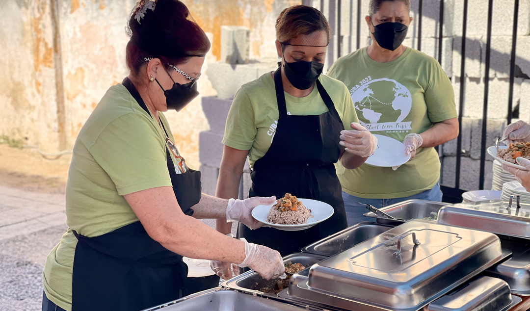 women putting together a plate of food