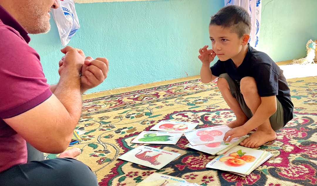 little boy learning sign language