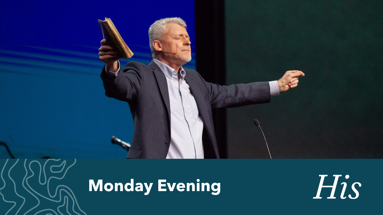 President John Stumbo holding his arms wide, holding a Bible.